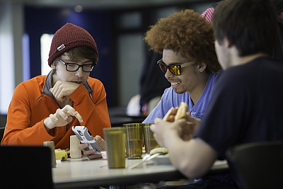 Three students eating in dining hall