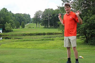 Zach Zoidis holding a golf club