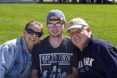 Parents and student pose on campus