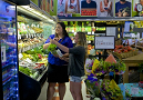 Two students stand in produce aisle